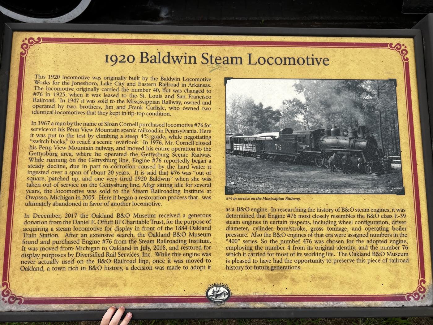 An interpretive plaque headed 1920 Baldwin Steam Locomotive, with several paragraphs of text and a black and white photograph of the engine in service on the Mississippian Railway.